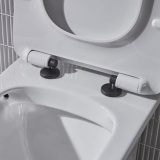 Lifestyle image of the Tavistock Loft Black Wrap Over Toilet Seat Hinge Cover Caps